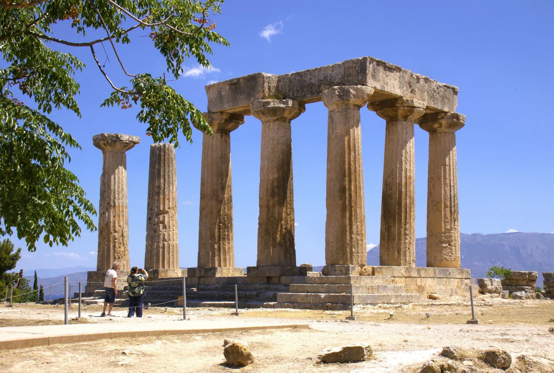 Doric columns of the Temple of Apollo at Ancient Corinth with Acrocorinth rising behind