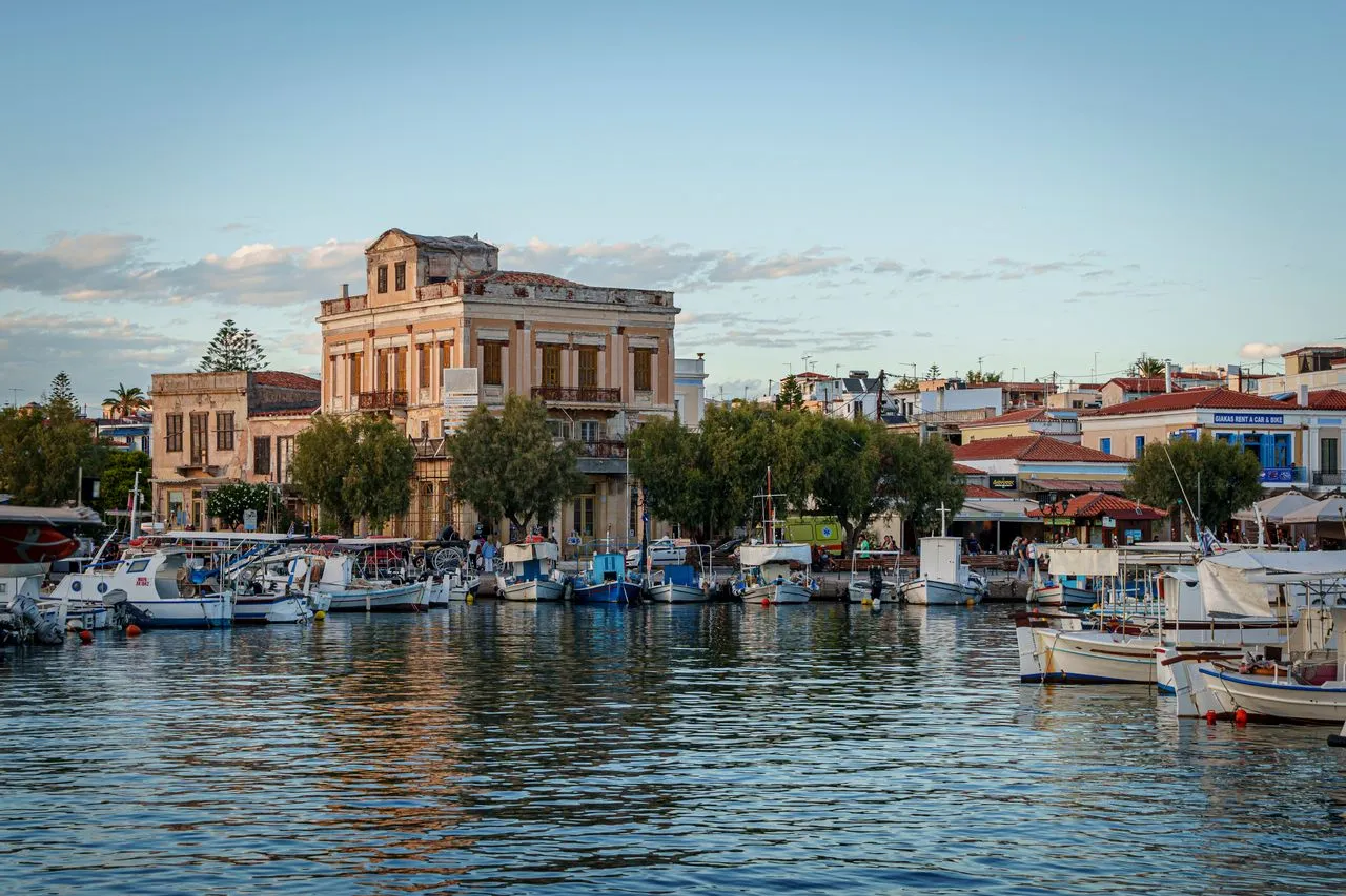 Fishing boats moored along the quiet waterfront marina of Aegina town in the Saronic Gulf
