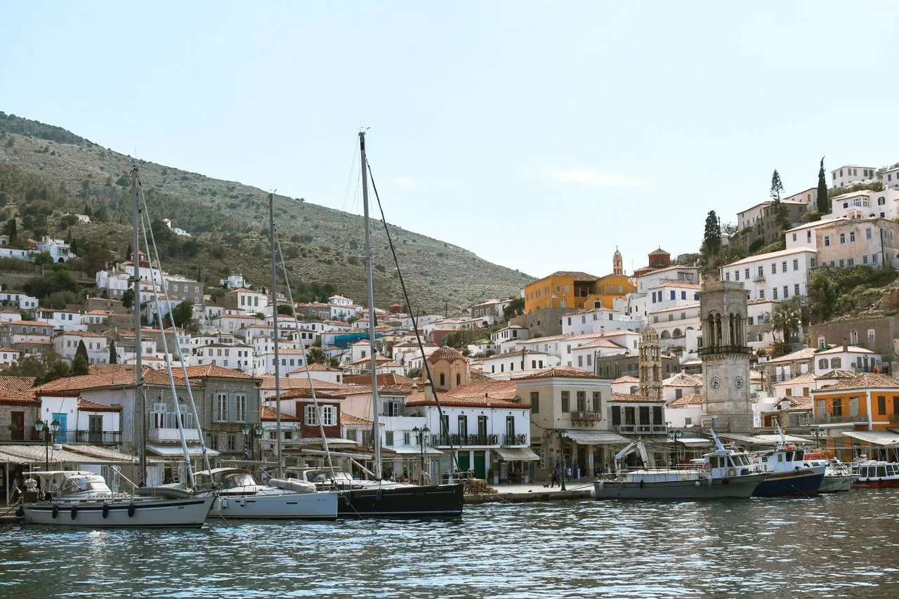 Stone mansions rising above the car-free harbour of Hydra in the Saronic Gulf